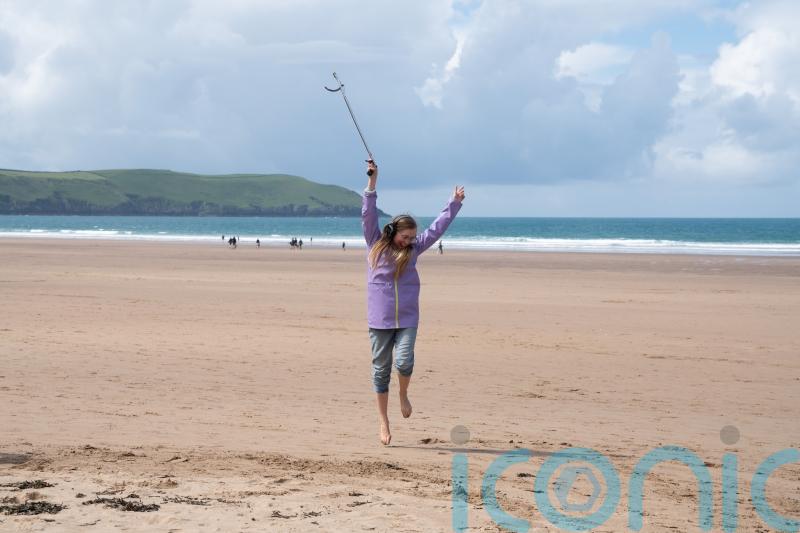 Beachgoers swap boogie boards for a boogie beach clean