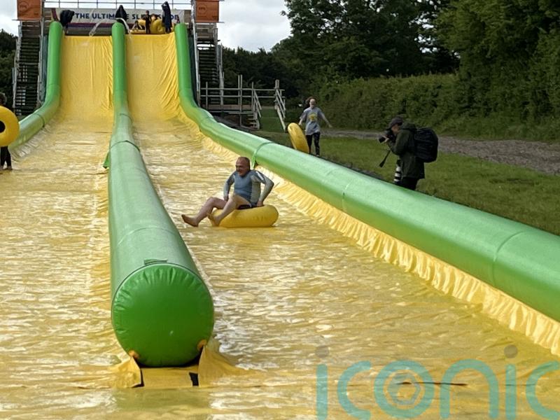 Sir Ed Davey defends election stunts as he races down water slide in rubber ring