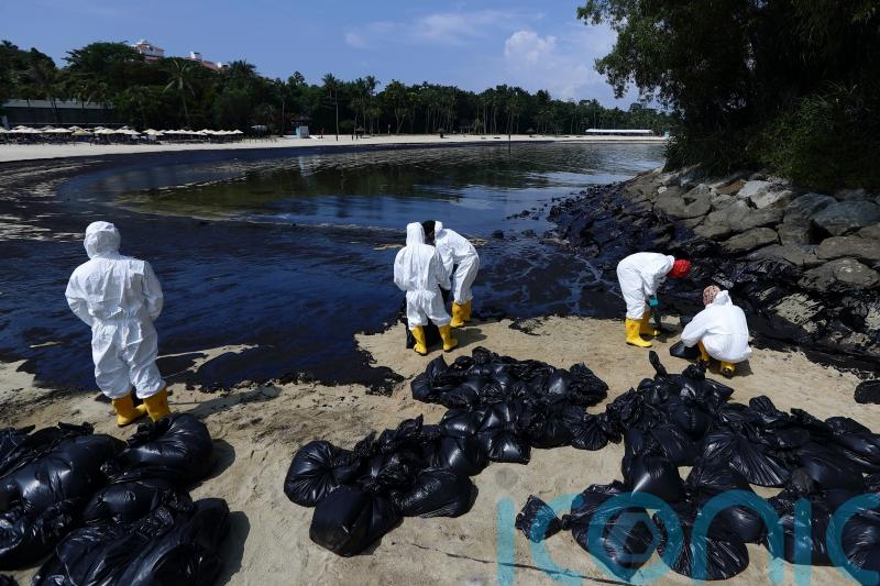 Singapore says dredger lost control and hit tanker causing oil spill