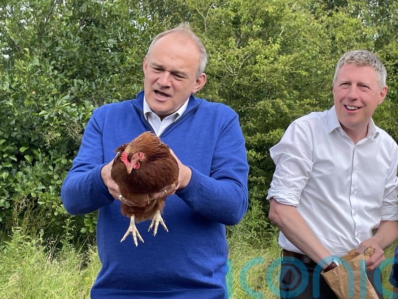 Sir Ed Davey warns water companies to invest as he feeds chickens on farm