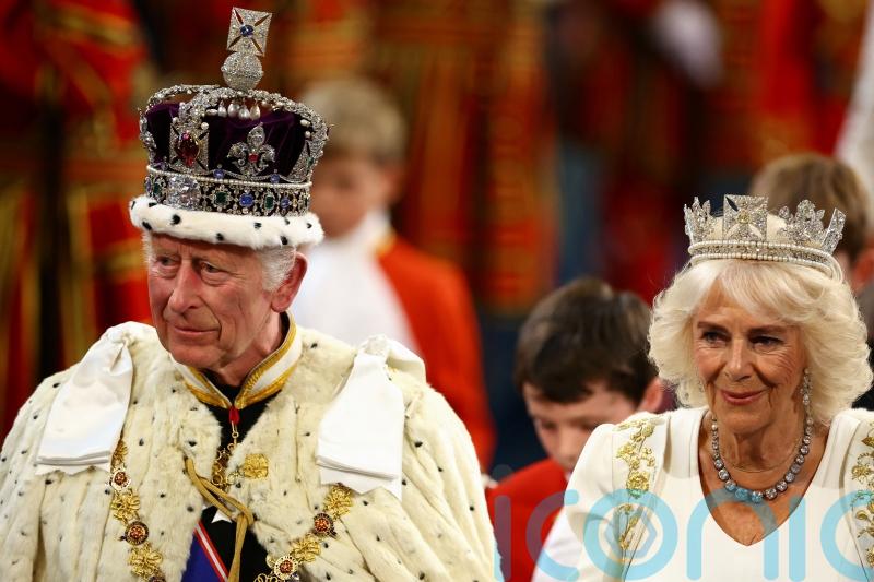 King opens Parliament supported by bandage-free birthday Queen