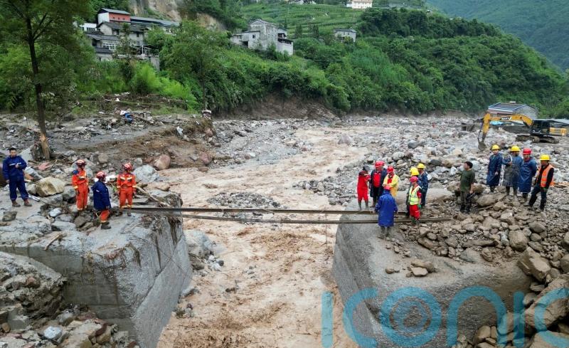 Search for missing after flooding and bridge collapse in China kill at least 25