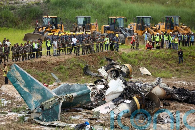 18 dead after plane slips off runway and crashes at Nepal airport
