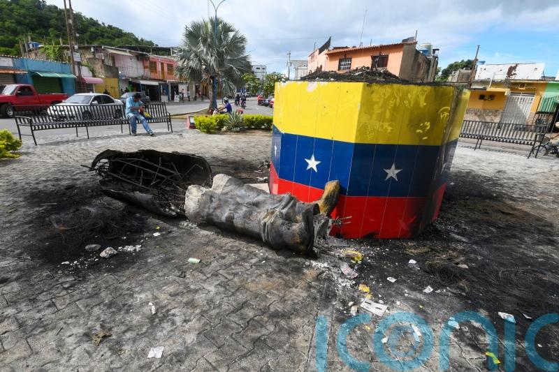 Hugo Chavez statues toppled across Venezuela in post-election unrest
