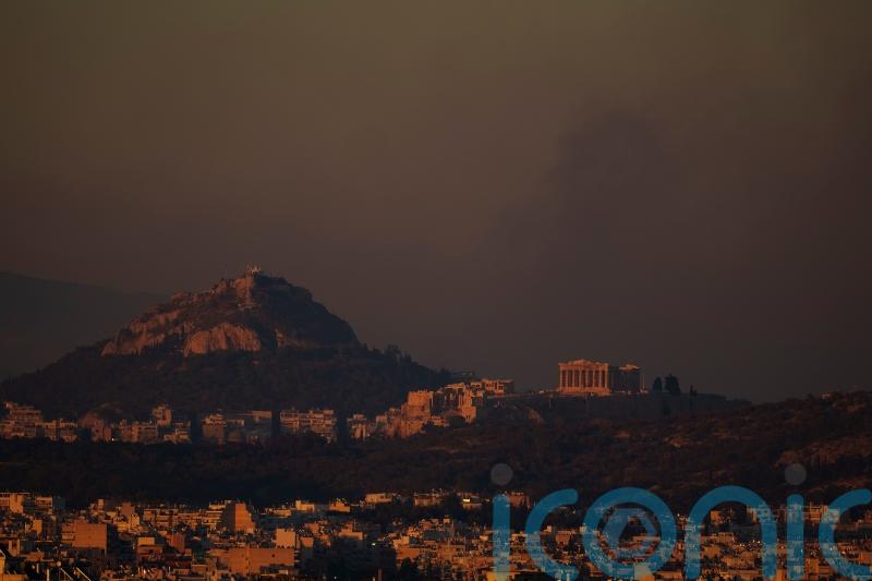 Crews battle scattered fires in Athens suburbs, helped by calmer winds
