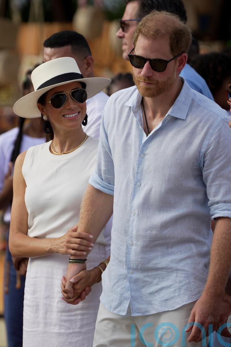 Meghan wears &lsquo;big smile&rsquo; during visit to Colombian music school with Harry