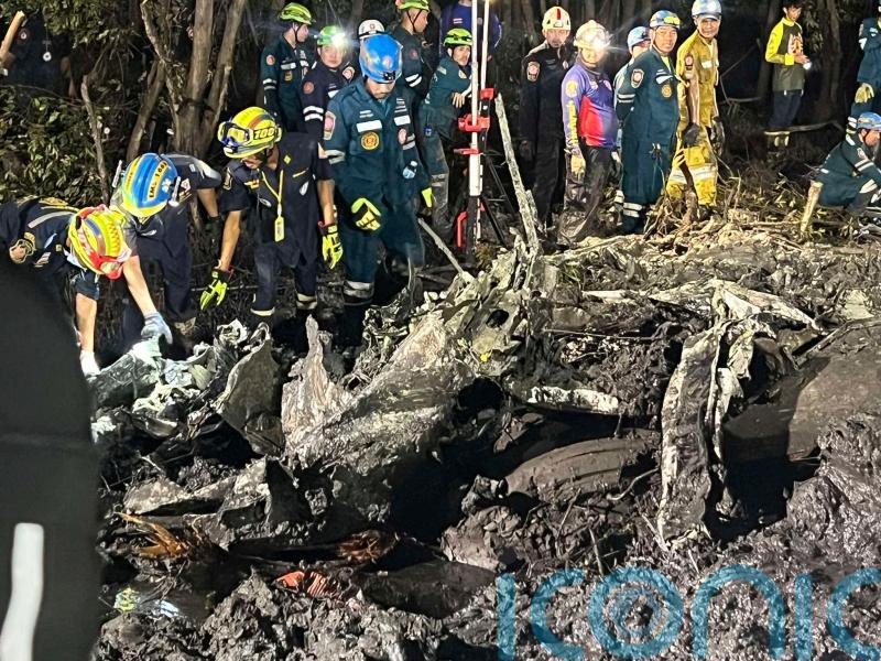 Searchers dig in muddy swamp where tourist plane crashed near Bangkok