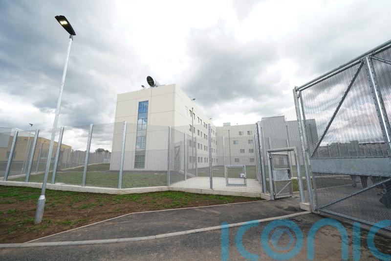 Three appear in court charged with prison murder