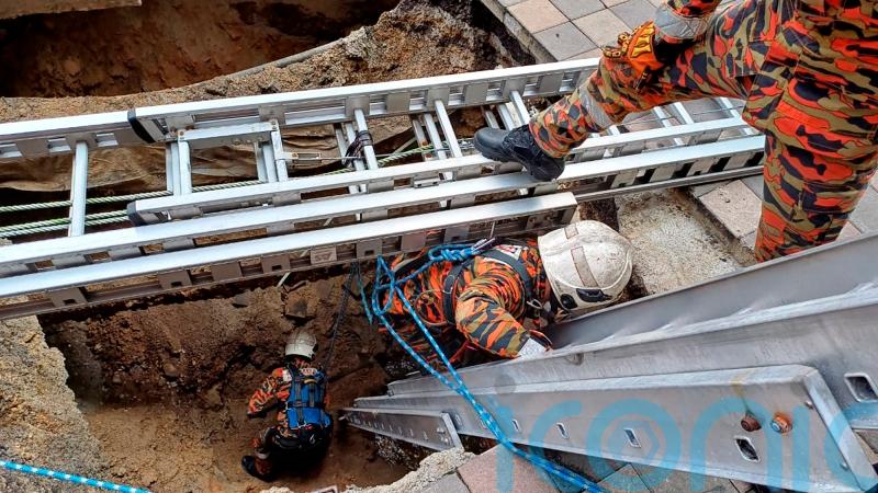 Woman plunges into 26ft hole after pavement collapses in Malaysian capital
