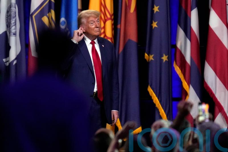 Trump responds to new indictment by sharing social media posts with QAnon links
