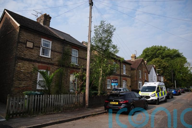 Three children and man found dead in Surrey house