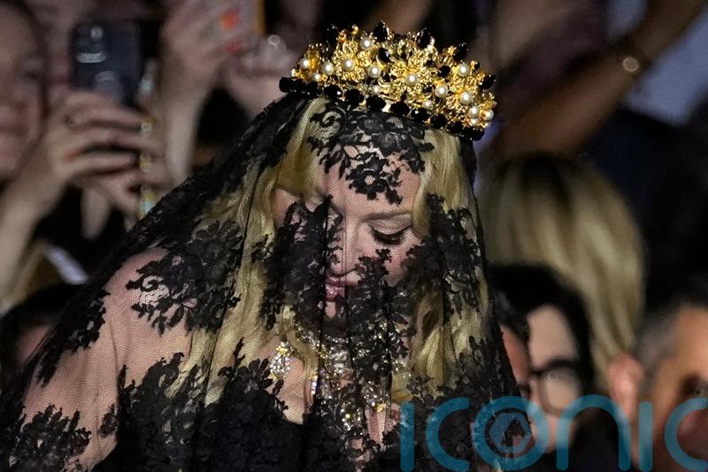 Madonna makes veiled entrance to Dolce & Gabbana for show marking 1990s heyday