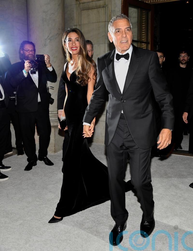 George Clooney plays photographer at star-studded charity event