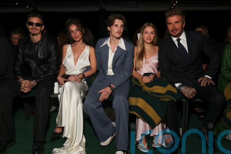 Victoria Beckham supported by family at Paris Fashion Week show