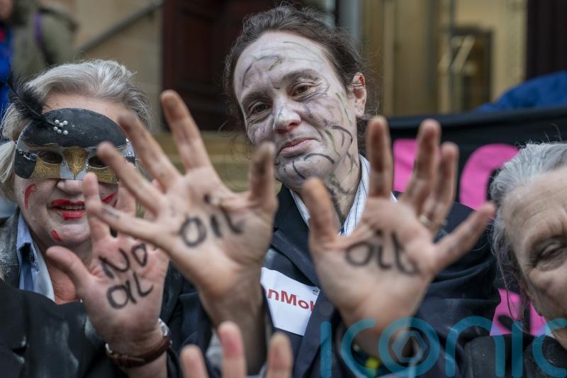 Climate activists in ‘zombie dance’ protest outside insurance offices