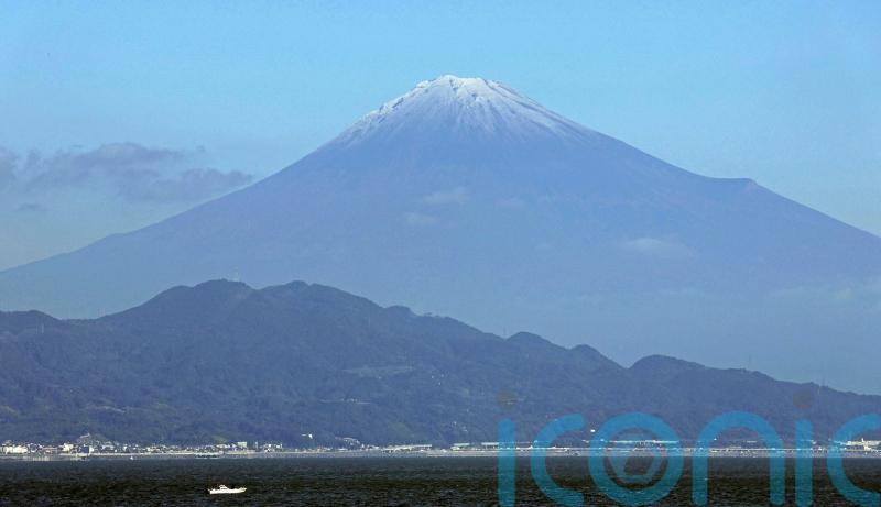 Mount Fuji gets its trademark snowcap after the longest delay in 130 years