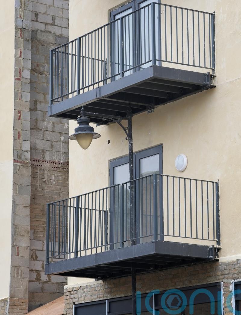 Developer builds balcony at block of flats around street lamppost