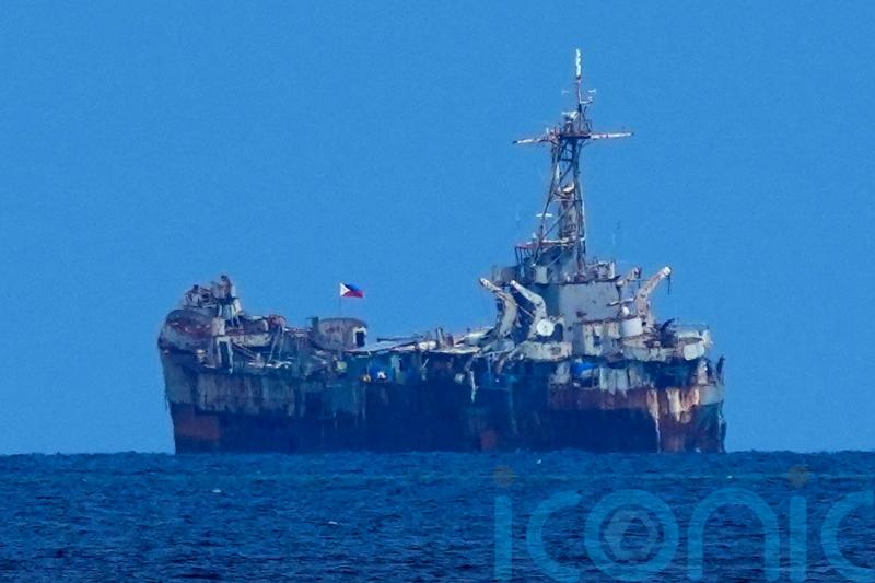 Philippine and Chinese forces avoid clash in disputed shoal under rare deal