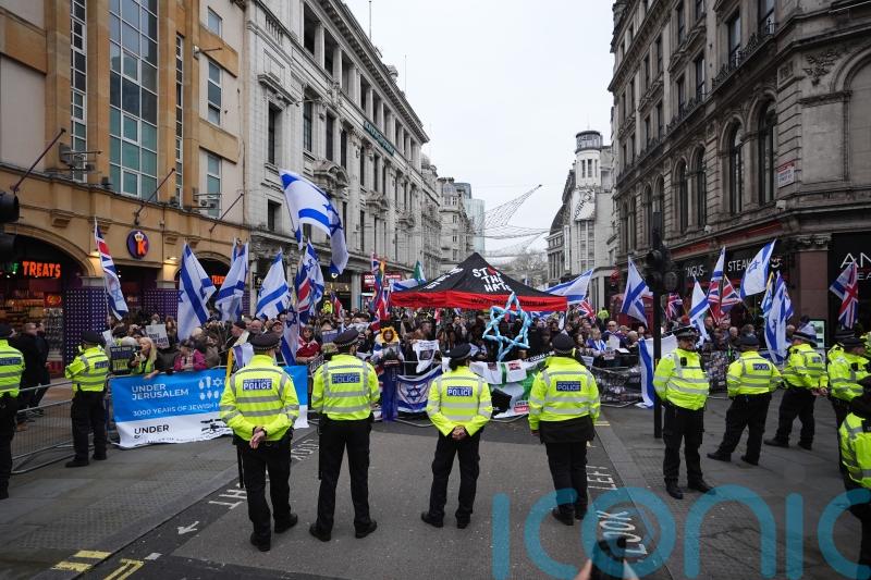 Pro-Palestine group and counter-protesters demonstrate near Christmas shoppers