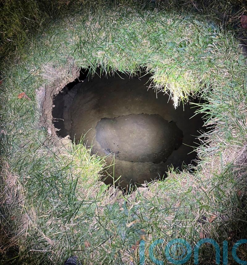Search extends into night for US woman who may have fallen into sinkhole