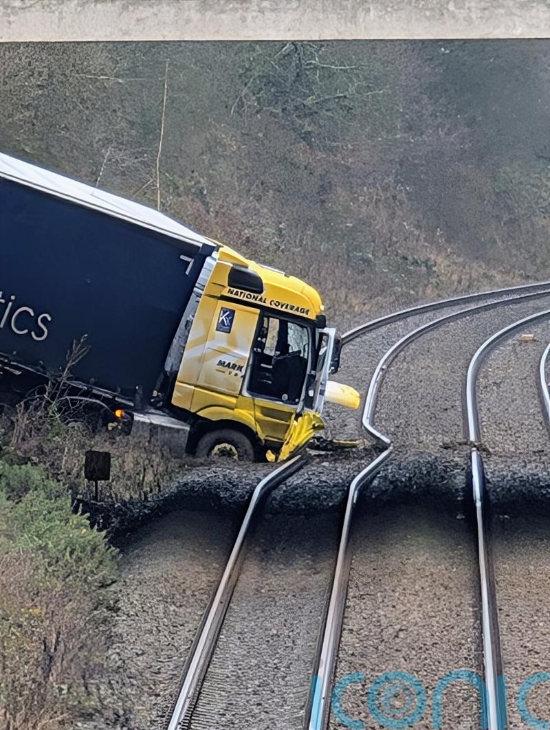 Man charged after lorry crashes onto railway line