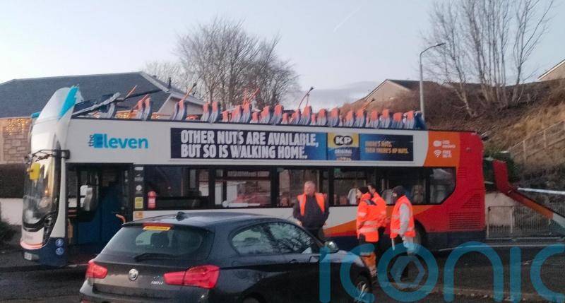 Four in hospital after roof of double-decker bus ripped off in bridge collision