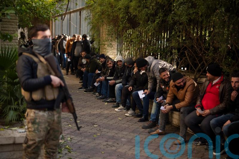 Ex-Syrian soldiers report to new rulers in hope of amnesty