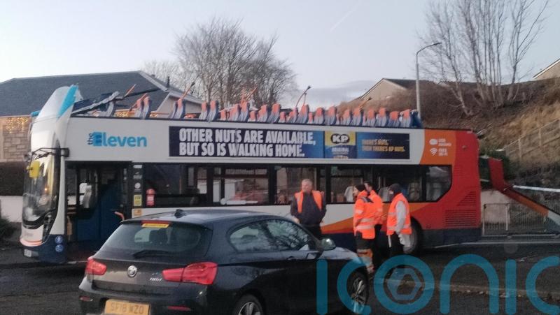 Man charged after bus crashes into railway bridge