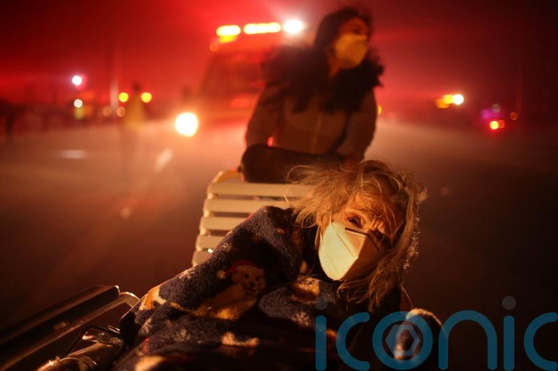 Thousands flee as wildfires burn out of control in Los Angeles