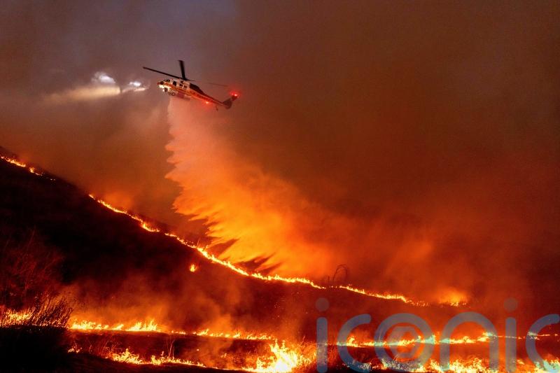 Firefighters hoping for break from fierce winds that have fuelled LA wildfires