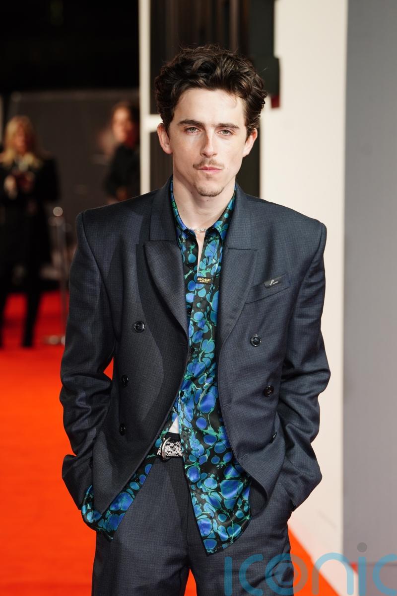 Timothee Chalamet arrives at A Complete Unknown UK premiere on a Lime bike