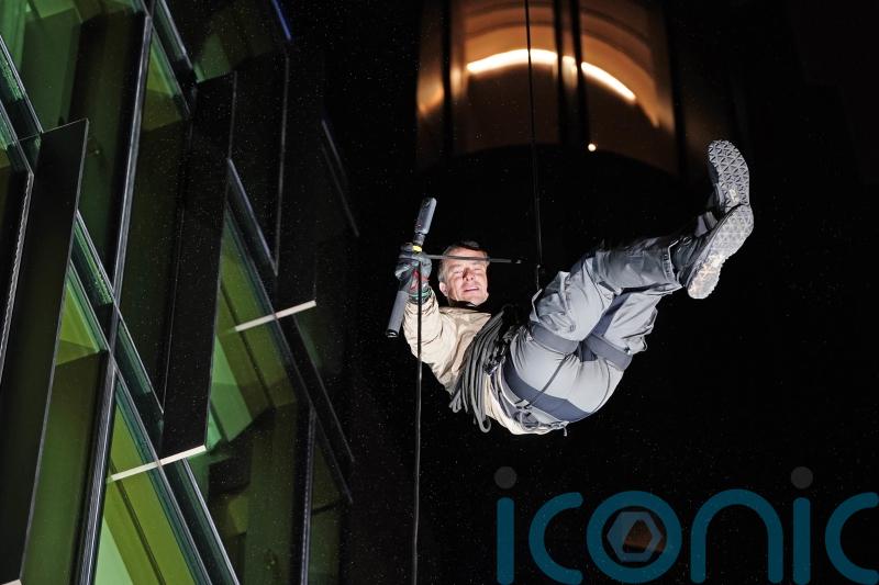 Bear Grylls abseils down London building for celebrity jungle show premiere