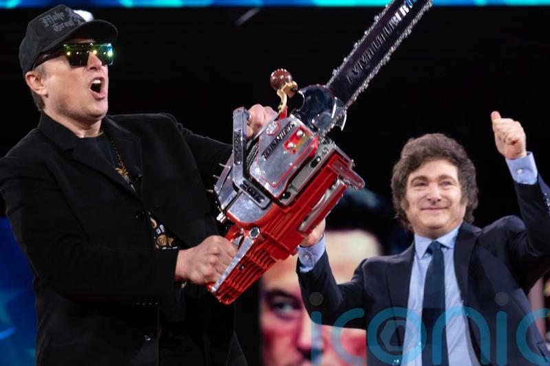 Musk wields chainsaw on stage at conservative conference
