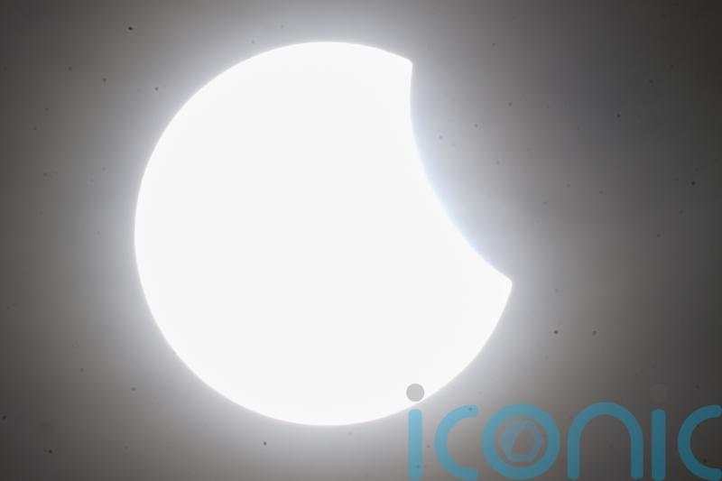 Skygazers catch glimpse of partial solar eclipse