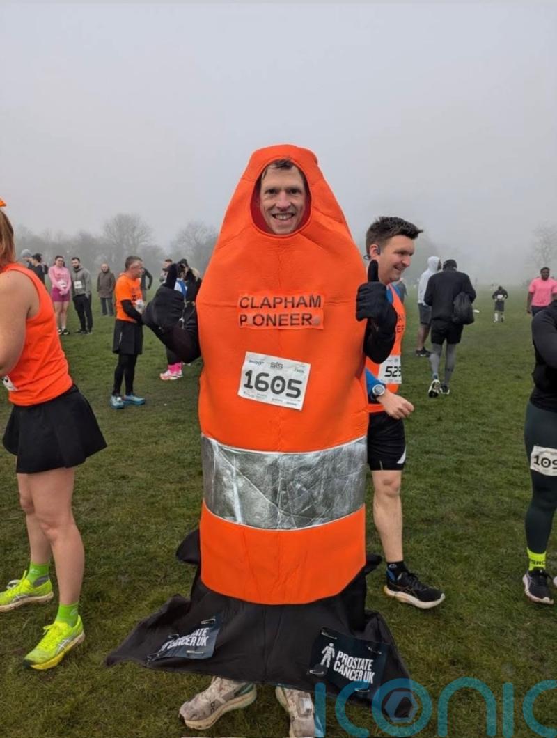 Runner aims to break record for fastest London Marathon run in traffic cone suit