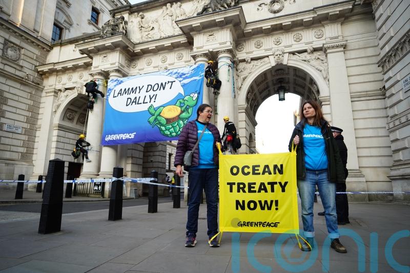 Greenpeace activists climb Foreign Office building over signing of ocean treaty
