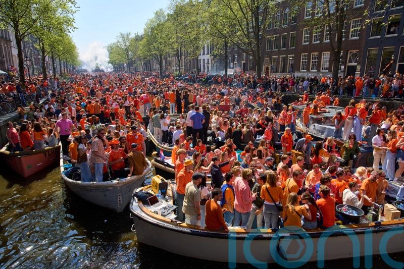 Orange-clad crowds cram into Dutch cities to celebrate king’s birthday