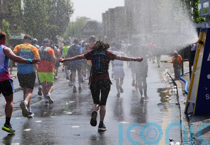 Thousands cross finish line of London Marathon as temperatures hit 22.2C