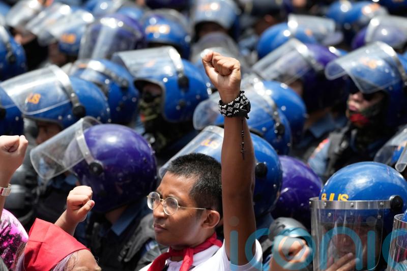Thousands across the globe march to celebrate May Day and protest over tariffs