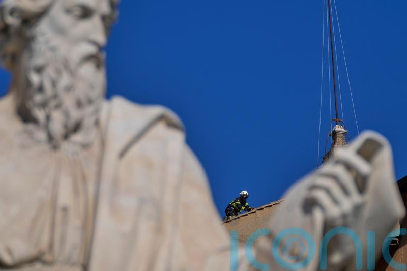 Vatican firefighters install chimney on Sistine Chapel roof for papal election