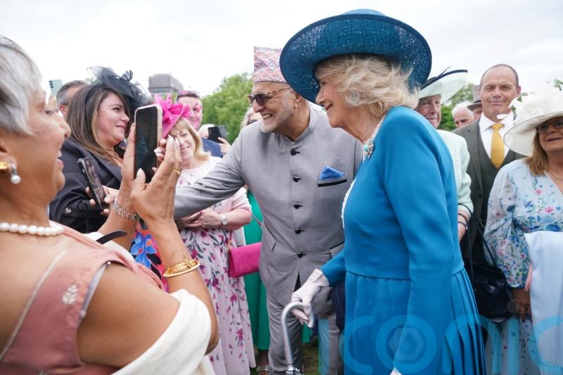 Camilla makes friends with ‘attention-seeking’ guide dog at palace garden party