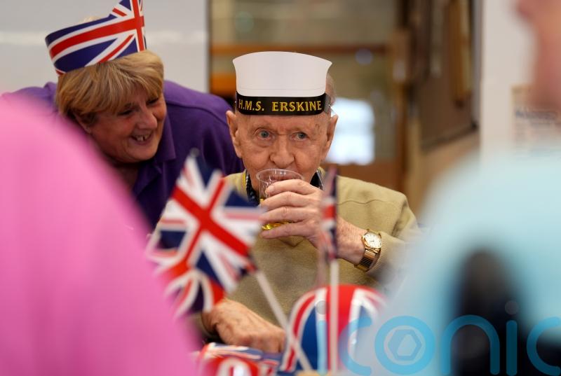 Veterans don Union flag hats and dance to 1940s tunes at VE Day street party