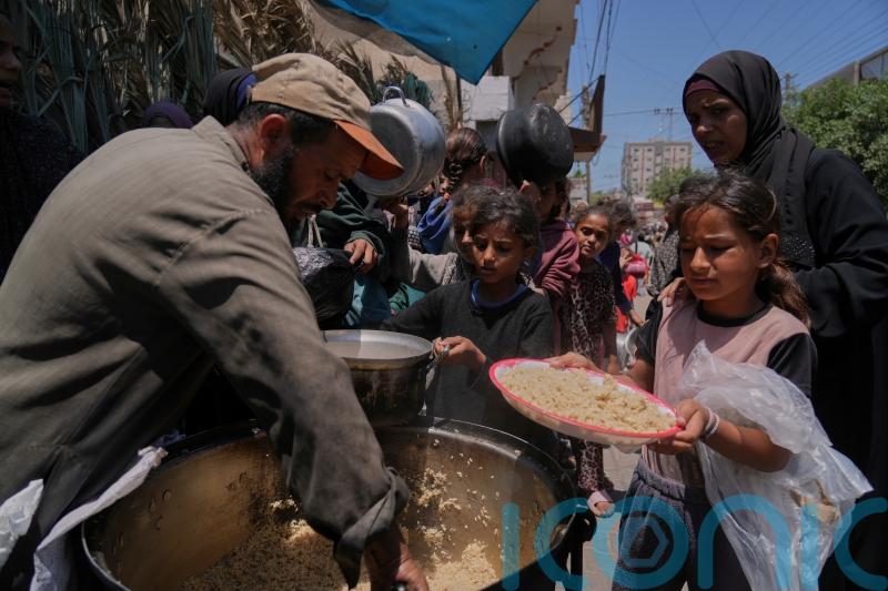 Palestinians block and empty dozens of UN food lorries in Gaza Strip