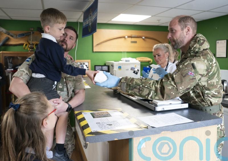 William in accommodation pledge as he dishes out bacon rolls to soldiers