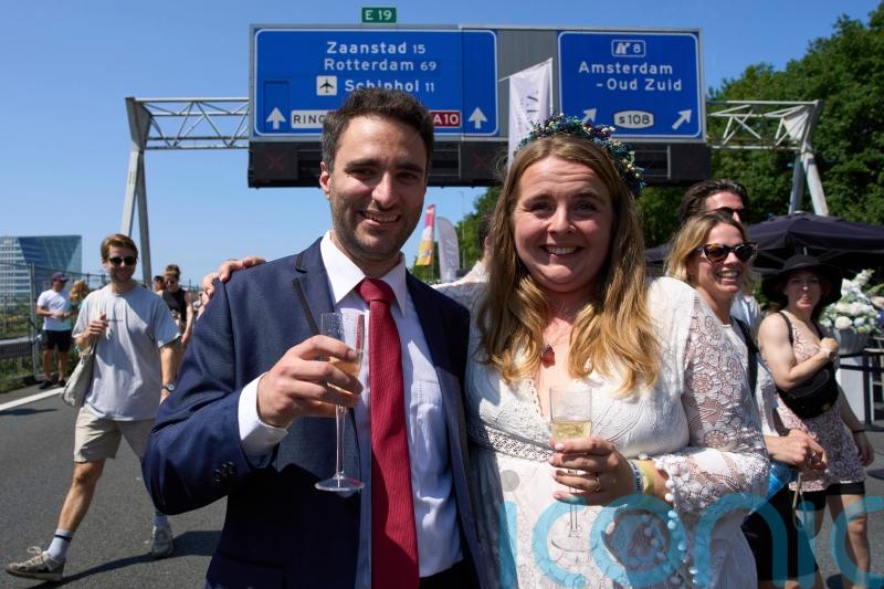 Couples tie the knot during a festival on an Amsterdam ring road