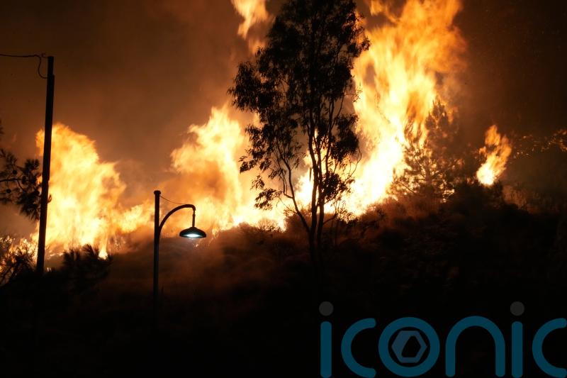 Firefighters battle wildfire burning out of control on Greek island