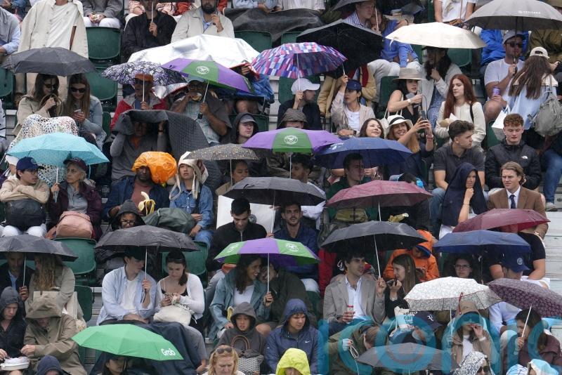 Spectators queue in ponchos as rain threatens to dampen sixth day of Wimbledon
