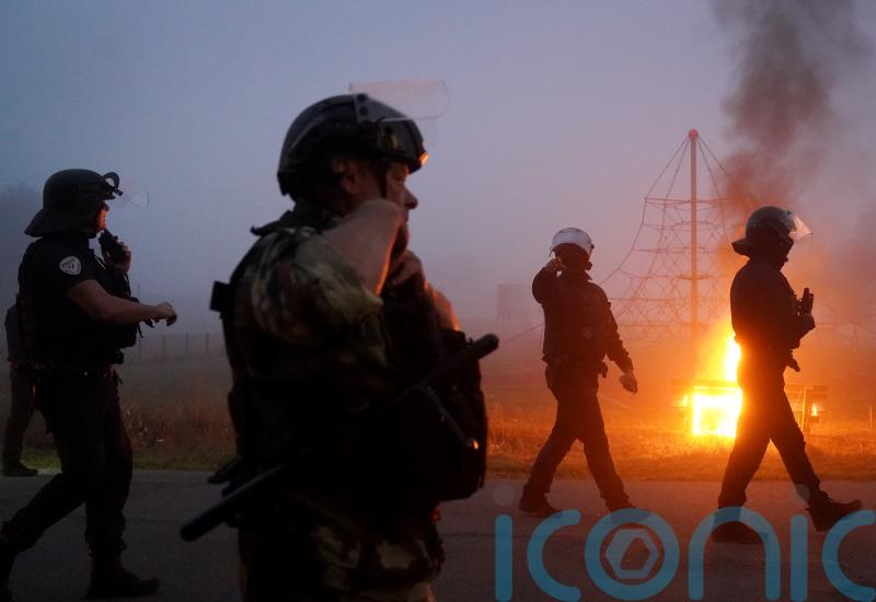French riot police in early morning clash with migrants in coastal town