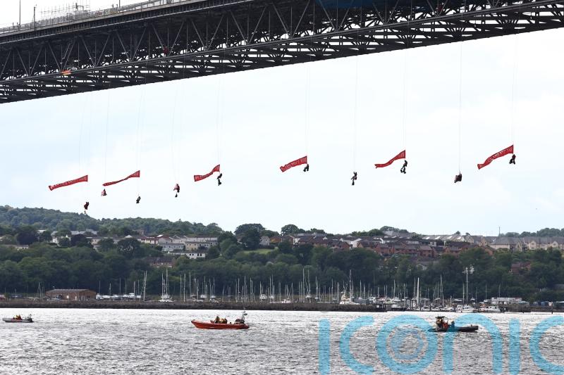 Forth Road Bridge closed as 10 Greenpeace activists abseil under it with flags