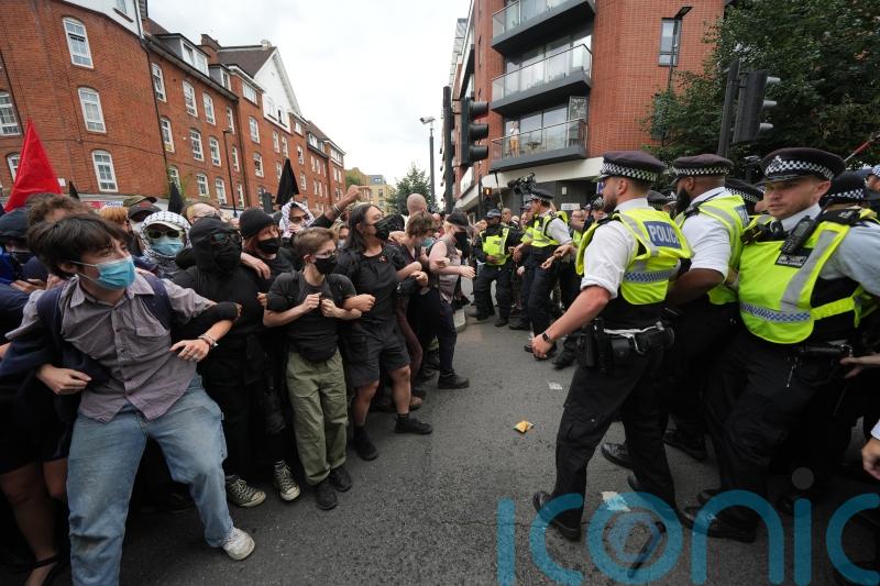 Demonstrators detained by police during rival protests outside asylum hotel